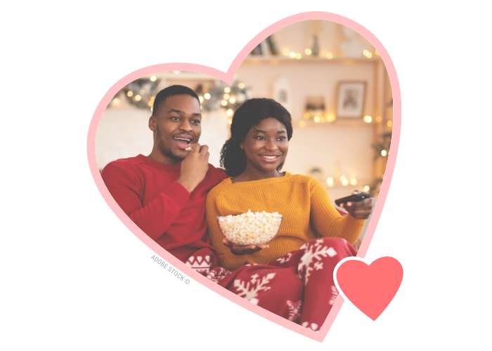 Couple watching movies together with popcorn