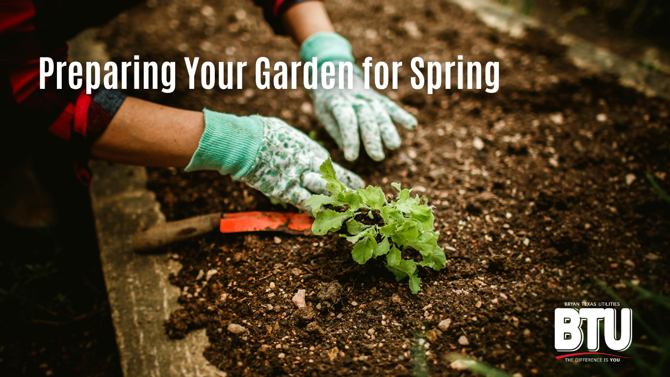 Preparing your garden for spring. A woman clears mulch for planting in a household garden.