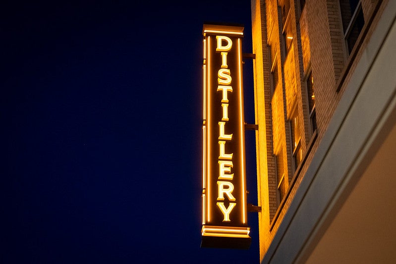 Neon sign outside Hush and Whisper distillery in Bryan, Texas