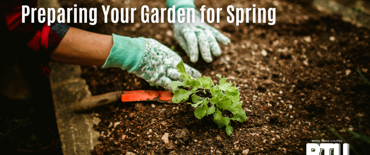 Preparing your garden for spring. A woman clears mulch for planting in a household garden.